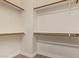 Walk-in closet with built-in shelving and laminate flooring at 695 S 221St Dr, Buckeye, AZ 85326