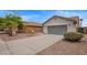 A charming two story home, featuring a desert landscape, and a two car garage at 695 S 221St Dr, Buckeye, AZ 85326