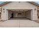 A spacious two car garage, complete with laminate floors, and a wall mounted air conditioning unit at 695 S 221St Dr, Buckeye, AZ 85326