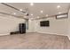 A spacious two car garage, complete with laminate floors, and a wall mounted air conditioning unit at 695 S 221St Dr, Buckeye, AZ 85326