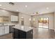 A modern kitchen with a center island, stainless steel appliances, and wood laminate flooring at 695 S 221St Dr, Buckeye, AZ 85326