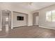 A spacious living room with wood laminate floors, neutral paint and a wall mounted television at 695 S 221St Dr, Buckeye, AZ 85326