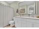 Bright bathroom with double vanity sinks and framed mirror at 717 N Abalone Ct, Gilbert, AZ 85233