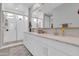 Bright bathroom features double sinks, white cabinets and a glass enclosed shower at 717 N Abalone Ct, Gilbert, AZ 85233