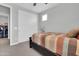 Well-lit bedroom with a closet, fan, and comfortable striped bed at 717 N Abalone Ct, Gilbert, AZ 85233