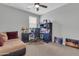 Bedroom features a ceiling fan, an office desk, and natural light from a window at 717 N Abalone Ct, Gilbert, AZ 85233