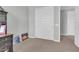 Bright bedroom featuring neutral carpeting, a closet, and white trim throughout the room at 717 N Abalone Ct, Gilbert, AZ 85233