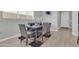 A view of a dining area featuring a gray table with seating for six and stylish decor at 717 N Abalone Ct, Gilbert, AZ 85233