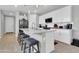 Bright kitchen features stainless appliances, white cabinets, and a large center island with bar stool seating at 717 N Abalone Ct, Gilbert, AZ 85233