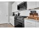 Bright kitchen features stainless appliances, white cabinets, and a large countertop at 717 N Abalone Ct, Gilbert, AZ 85233