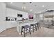 Bright kitchen features stainless appliances, white cabinets, and a large center island with bar stool seating at 717 N Abalone Ct, Gilbert, AZ 85233