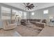 Inviting living room features a sectional sofa, a ceiling fan, and plenty of natural light at 717 N Abalone Ct, Gilbert, AZ 85233