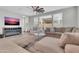 Bright living room with an open floor plan, modern furnishings, and a ceiling fan above at 717 N Abalone Ct, Gilbert, AZ 85233