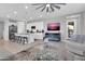 Bright living room with an open floor plan, modern furnishings, and a ceiling fan above at 717 N Abalone Ct, Gilbert, AZ 85233