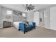 Bright main bedroom with large windows, a ceiling fan, and stylish blue couch at 717 N Abalone Ct, Gilbert, AZ 85233