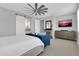 Spacious main bedroom features a barn door to bath and ceiling fan at 717 N Abalone Ct, Gilbert, AZ 85233