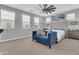 Bright main bedroom with large windows, a ceiling fan, and stylish blue couch at 717 N Abalone Ct, Gilbert, AZ 85233