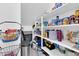 A well-stocked and organized walk-in pantry has shelves stocked with food and essentials at 717 N Abalone Ct, Gilbert, AZ 85233