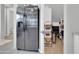 A stainless steel refrigerator sits next to a walk-in pantry with organized shelves at 717 N Abalone Ct, Gilbert, AZ 85233