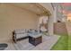 Covered patio showcases cozy seating, a modern fire pit, pavers, and artificial turf at 717 N Abalone Ct, Gilbert, AZ 85233