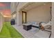 Covered patio boasts a fire pit, comfortable seating, grill, and artificial turf at 717 N Abalone Ct, Gilbert, AZ 85233