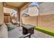 Covered patio with pavers features a comfortable seating area, fire pit, and outdoor lighting at 717 N Abalone Ct, Gilbert, AZ 85233