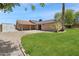Backyard with gravel landscaping, grassy area and covered patio at 7337 E Ivyglen St, Mesa, AZ 85207