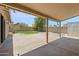 This backyard features a covered patio, grassy area, and desert landscaping for low maintenance and water conservation at 7337 E Ivyglen St, Mesa, AZ 85207