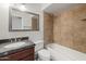 Bathroom featuring granite countertop, vanity, tiled shower, and a large mirror at 7337 E Ivyglen St, Mesa, AZ 85207