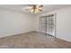 Neutral bedroom with ceramic tile flooring, ceiling fan, and sliding glass door to the outside at 7337 E Ivyglen St, Mesa, AZ 85207