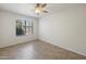 Bright bedroom with ceramic tile flooring and a window overlooking the front yard at 7337 E Ivyglen St, Mesa, AZ 85207