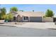 Single-story home featuring a neutral exterior, desert landscaping, and a two-car garage at 7337 E Ivyglen St, Mesa, AZ 85207