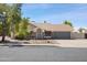 Charming home with a well-manicured lawn, desert landscaping, and a two-car garage at 7337 E Ivyglen St, Mesa, AZ 85207