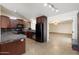 Kitchen with black appliances, dark wood cabinets, and granite countertops at 7337 E Ivyglen St, Mesa, AZ 85207