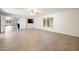 Spacious living room with tile flooring and neutral walls, flooded with natural light at 7337 E Ivyglen St, Mesa, AZ 85207
