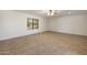 Large living room featuring ceramic tile flooring, a ceiling fan, and natural lighting at 7337 E Ivyglen St, Mesa, AZ 85207