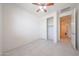 Bedroom with ceiling fan, tile floors, and closet with opened doors at 7648 W Kerby Ave, Phoenix, AZ 85043
