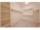 A well-organized walk-in closet featuring open shelving and hanging rods, ideal for efficient storage at 7648 W Kerby Ave, Phoenix, AZ 85043