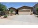 Charming single-story home with a two-car garage and a well-maintained front yard at 7648 W Kerby Ave, Phoenix, AZ 85043