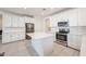 Kitchen featuring an island, stainless steel appliances and white cabinets at 7648 W Kerby Ave, Phoenix, AZ 85043