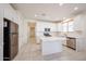 Bright kitchen featuring stainless steel appliances, white cabinets, and an island at 7648 W Kerby Ave, Phoenix, AZ 85043