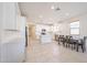 This well-lit kitchen has white cabinets, an island, and a dining table at 7648 W Kerby Ave, Phoenix, AZ 85043