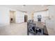 Bright kitchen featuring white cabinets, subway tile backsplash, stainless steel appliances, and a dining table at 7648 W Kerby Ave, Phoenix, AZ 85043