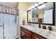 Bathroom with granite countertops, wood cabinets, and shower with glass door at 8500 E Southern Ave # 510, Mesa, AZ 85209