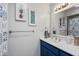 Bright bathroom featuring a blue vanity, white sink, and stylish artwork at 8653 S 51St St # 2, Phoenix, AZ 85044
