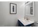 Bathroom vanity features a blue cabinet, a framed mirror, and a neutral colored countertop at 8653 S 51St St # 2, Phoenix, AZ 85044
