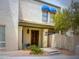 Multi-story townhome with a tiled entry roof, decorative lighting, flowers, and an ADT security sign at 8653 S 51St St # 2, Phoenix, AZ 85044