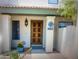 Close-up of a front door with tiled roof, decorative lighting, flowers, and a house number at 8653 S 51St St # 2, Phoenix, AZ 85044