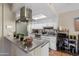 Updated kitchen with stainless hood, white cabinets, and convenient breakfast bar area at 8653 S 51St St # 2, Phoenix, AZ 85044