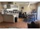 Open concept kitchen with white cabinets, stainless steel appliances, and an adjacent dining area at 8653 S 51St St # 2, Phoenix, AZ 85044